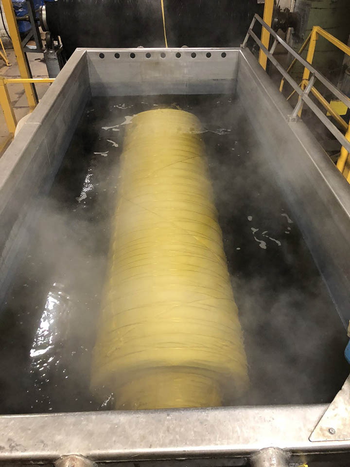 Beam dyeing of fabric. A filtration system cleans all water