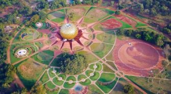 At its heart lies the Matrimandir, surrounded by twelve petal-like structures and gardens, forming an area called “Peace,” which will eventually be encircled by a lake.