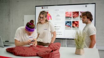 Brakeable’s Stefan Hauser, Founder & CEO, Kim Schmidt, CPO, and Marc Berli, Co-Founder & CTO inspecting a damaged textile. Photo courtesy Brakeable